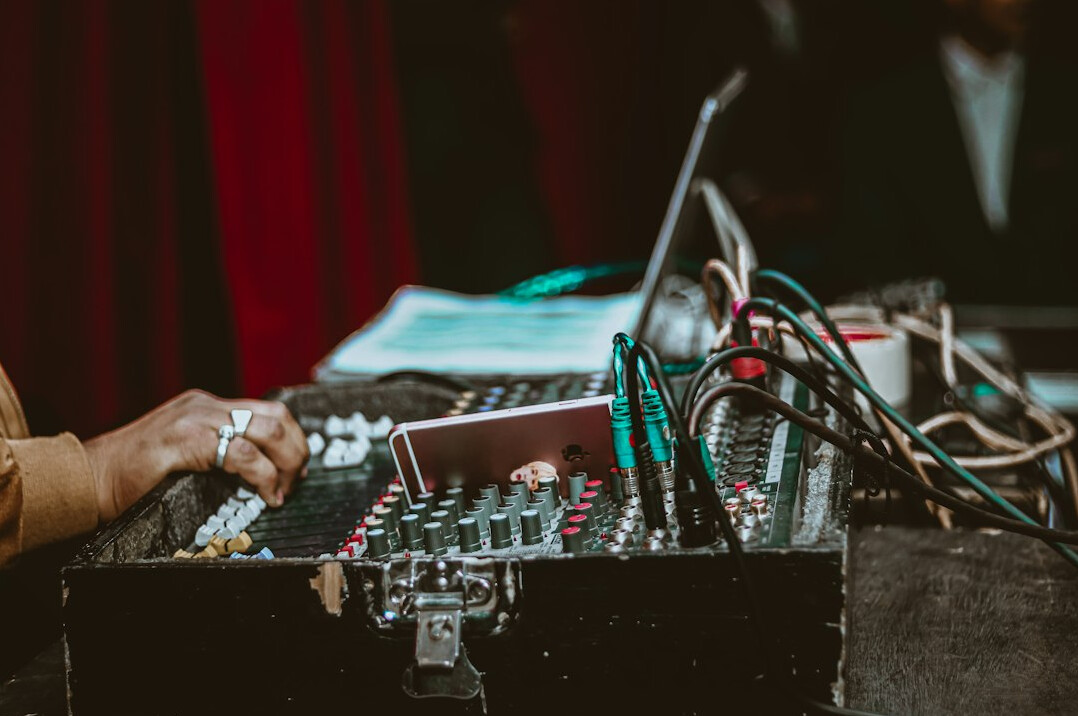 Sound engineer adjusting a broadcast audio mixing console