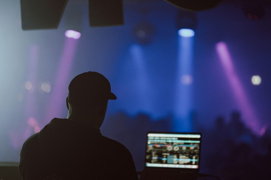 Production crew reviewing footage on a laptop in a studio